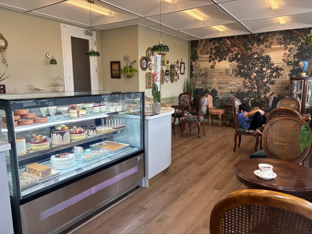 Pastry display case and garden mural at CakeToronto café