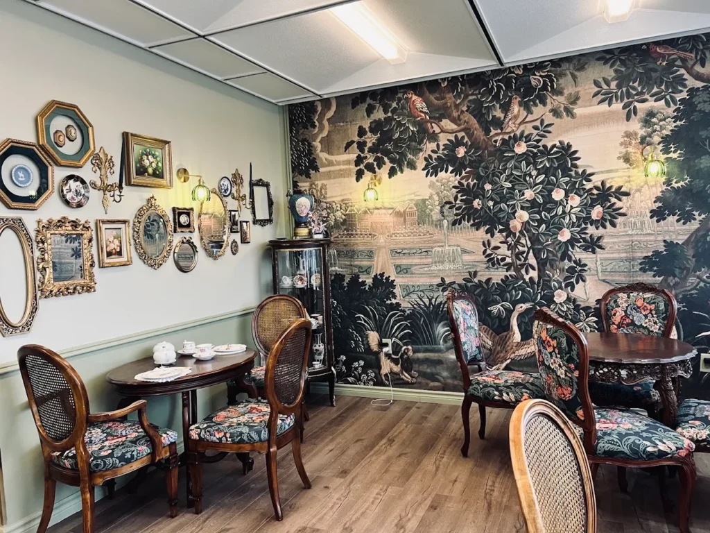 Dining room with garden mural and floral vintage chairs at CakeToronto