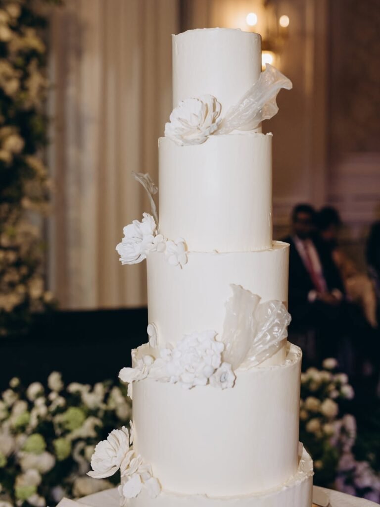 Multi-tier wedding cake with sugar flowers by CakeToronto